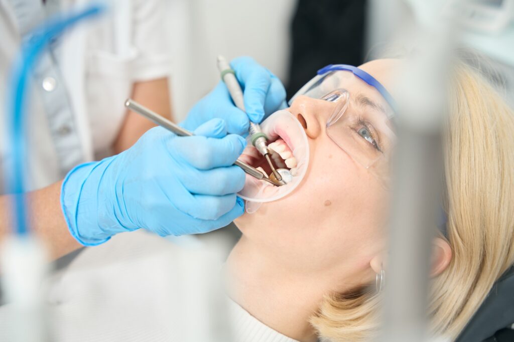 Dentist performing preventive dental checkup and cleaning